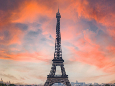 The Eiffel Tower silhouetted against a vibrant sunset sky in Paris.