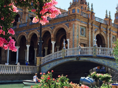 Beautiful bridge, canal, and ornate architecture at Plaza de España in Seville, Spain.