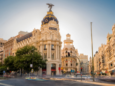 Historic Metropolis Building and Gran Vía boulevard in Madrid, Spain.