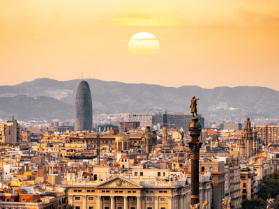 Sunset view of Barcelona skyline featuring the Columbus Monument and city landmarks