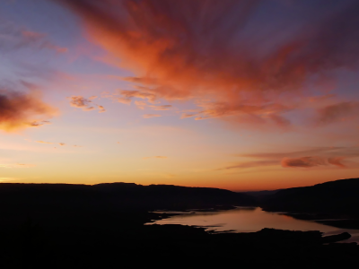 Witness a breathtaking sunset over the Middle Atlas Mountains, where dramatic skies and tranquil landscapes create unforgettable views.